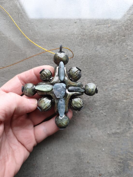 A gemstone cross pendant